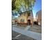 Two-story house with tan and red exterior, two-car garage, and landscaping at 7827 W Cypress St, Phoenix, AZ 85035