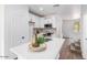 Modern kitchen with white cabinets and quartz countertops at 7827 W Cypress St, Phoenix, AZ 85035