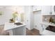 Kitchen island with white quartz countertop and sink at 7827 W Cypress St, Phoenix, AZ 85035