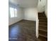 Living room with hardwood floors and staircase at 7827 W Cypress St, Phoenix, AZ 85035