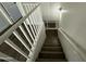 Upstairs stairway with wooden steps and white railing at 7827 W Cypress St, Phoenix, AZ 85035