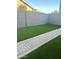 Artificial turf lawn, brick pathway, and block wall at 7870 W Cheryl Dr, Peoria, AZ 85345