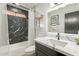 Modern bathroom with marble vanity and dark tile shower at 7870 W Cheryl Dr, Peoria, AZ 85345