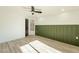 Light and airy bedroom with a door and green accent wall at 7870 W Cheryl Dr, Peoria, AZ 85345