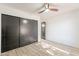 Bright bedroom with dark sliding doors and wood-look flooring at 7870 W Cheryl Dr, Peoria, AZ 85345