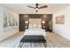 Spacious bedroom with ceiling fan, large bed, and dark accent wall at 7870 W Cheryl Dr, Peoria, AZ 85345