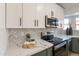 Stylish kitchen features marble countertops and herringbone backsplash at 7870 W Cheryl Dr, Peoria, AZ 85345