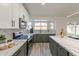 Spacious kitchen with marble countertops and green cabinets at 7870 W Cheryl Dr, Peoria, AZ 85345