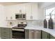 Stainless steel appliances and marble countertops highlight this modern kitchen at 7870 W Cheryl Dr, Peoria, AZ 85345