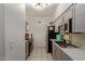 Bright kitchen with gray cabinets, marble countertops, and stainless steel appliances at 8020 E Thomas Rd # 330, Scottsdale, AZ 85251