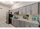 Updated kitchen featuring gray cabinets, marble countertops, and a stylish backsplash at 8020 E Thomas Rd # 330, Scottsdale, AZ 85251