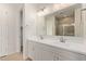 Bathroom with a dual sink vanity and tile shower with glass door at 8333 N 54Th Ln, Glendale, AZ 85302