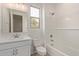 Clean, bright bathroom with white subway tile, a tub, and a window above the toilet at 8333 N 54Th Ln, Glendale, AZ 85302