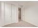 Bedroom showcasing sliding closet doors, carpet flooring, and a hallway entrance at 8333 N 54Th Ln, Glendale, AZ 85302