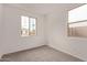 Sunlit bedroom with two windows offering neighborhood views and neutral carpet at 8333 N 54Th Ln, Glendale, AZ 85302