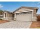 Inviting home featuring a well-lit garage and tasteful stone veneer, enhanced by tidy front yard landscaping at 8333 N 54Th Ln, Glendale, AZ 85302