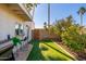 Backyard with artificial turf, BBQ grill, and patio seating at 8602 E San Alfredo Dr, Scottsdale, AZ 85258