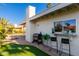 Home's exterior features a patio, grill, and grassy area near a pool at 8602 E San Alfredo Dr, Scottsdale, AZ 85258