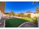 Landscaped backyard with a swimming pool and grassy area at 8602 E San Alfredo Dr, Scottsdale, AZ 85258