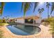 Inviting kidney-shaped pool with patio and lush landscaping at 8602 E San Alfredo Dr, Scottsdale, AZ 85258