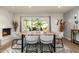 Light and bright dining area with a wooden table and seating for six at 8602 E San Alfredo Dr, Scottsdale, AZ 85258