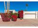 Single story home with white stucco exterior, red flowering bushes, and a two-car garage at 8602 E San Alfredo Dr, Scottsdale, AZ 85258