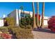 Front view of a single story home with white stucco exterior and lush landscaping at 8602 E San Alfredo Dr, Scottsdale, AZ 85258