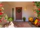 Inviting front entry with terracotta tile flooring, wooden bench, and a wreath on the door at 8602 E San Alfredo Dr, Scottsdale, AZ 85258