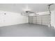 Garage with automatic door opener and painted floor at 8602 E San Alfredo Dr, Scottsdale, AZ 85258