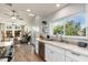 Modern kitchen with white cabinets, stainless steel appliances, and a view to the backyard at 8602 E San Alfredo Dr, Scottsdale, AZ 85258