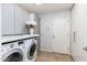 Bright laundry room with washer, dryer, and ample storage at 8602 E San Alfredo Dr, Scottsdale, AZ 85258