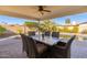 Covered patio with dining set, pool view, and fire pit at 8602 E San Alfredo Dr, Scottsdale, AZ 85258