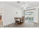 Cozy dining area with a wooden table and chairs near sliding doors at 9518 W Shasta Dr, Sun City, AZ 85351