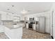 Updated kitchen with stainless steel appliances and white cabinetry at 9518 W Shasta Dr, Sun City, AZ 85351