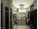 Spacious walk-in closet with ample shelving and a washer at 10784 E Pinnacle Peak Rd, Scottsdale, AZ 85255