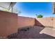 Small backyard with brick wall and fire pit at 10863 W Thunderbird Blvd, Sun City, AZ 85351