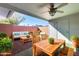 Charming covered patio with stylish outdoor seating and a ceiling fan at 10863 W Thunderbird Blvd, Sun City, AZ 85351