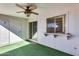 Covered patio with sliding glass door and artificial turf at 10863 W Thunderbird Blvd, Sun City, AZ 85351