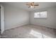 Spacious bedroom with ceiling fan, carpet, and ample natural light at 111 E Pebble Beach Dr, Tempe, AZ 85282