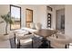 Modern dining room with wooden table, plush chairs, and natural light at 11972 E Yearling Rd # 20, Scottsdale, AZ 85255