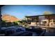Backyard pool with outdoor kitchen, television, waterfall feature, and mountain views at 11972 E Yearling Rd # 20, Scottsdale, AZ 85255