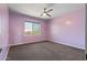Cozy bedroom with purple walls, ceiling fan, and window view at 14035 E Sahuaro Dr, Scottsdale, AZ 85259