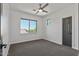 Bright bedroom featuring a ceiling fan and large window at 14035 E Sahuaro Dr, Scottsdale, AZ 85259