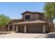 Two-story house with a two-car garage and desert landscaping at 14035 E Sahuaro Dr, Scottsdale, AZ 85259
