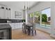 Modern kitchen with white cabinets, a breakfast nook, and pool view at 14035 E Sahuaro Dr, Scottsdale, AZ 85259