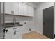 Well-lit laundry room with sink and cabinets at 14035 E Sahuaro Dr, Scottsdale, AZ 85259