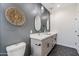 Modern bathroom with double vanity, gray walls, and hexagon tile floor at 1642 E Monte Vista Rd # 4, Phoenix, AZ 85006