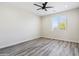 Simple bedroom with grey wood-look floors and window with blinds at 1642 E Monte Vista Rd # 4, Phoenix, AZ 85006