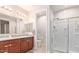 Main bathroom with double sinks and a walk-in shower at 17536 W Desert Bloom St, Goodyear, AZ 85338