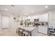Modern kitchen with granite countertops and white cabinets at 17536 W Desert Bloom St, Goodyear, AZ 85338